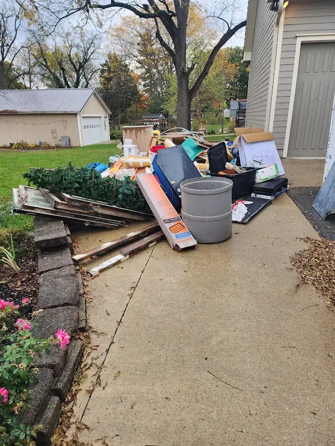 Dumpster being loaded with debris for Estate Cleanout Dumpster Rental in North Reading